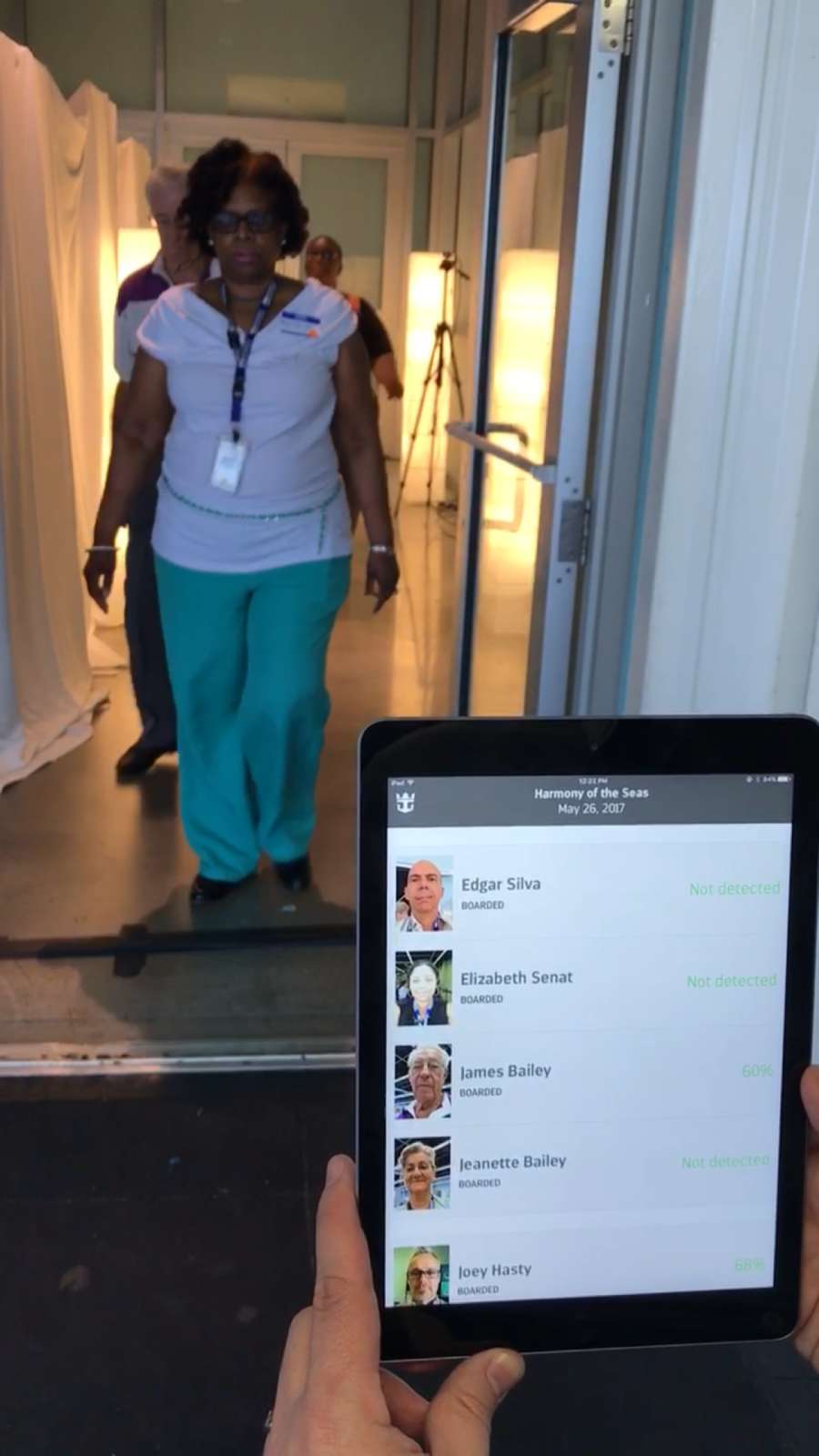 Passengers walking through Royal Caribbean facial recognition terminal